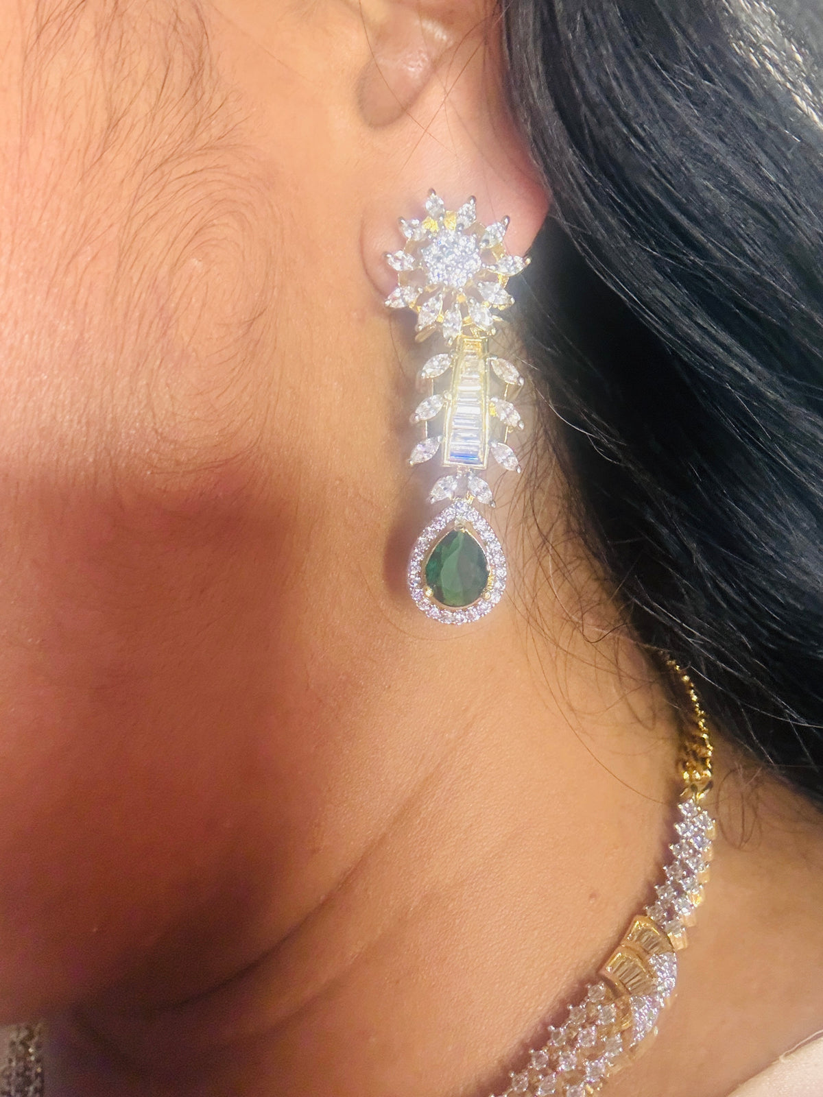 Green stone CZ next to real
